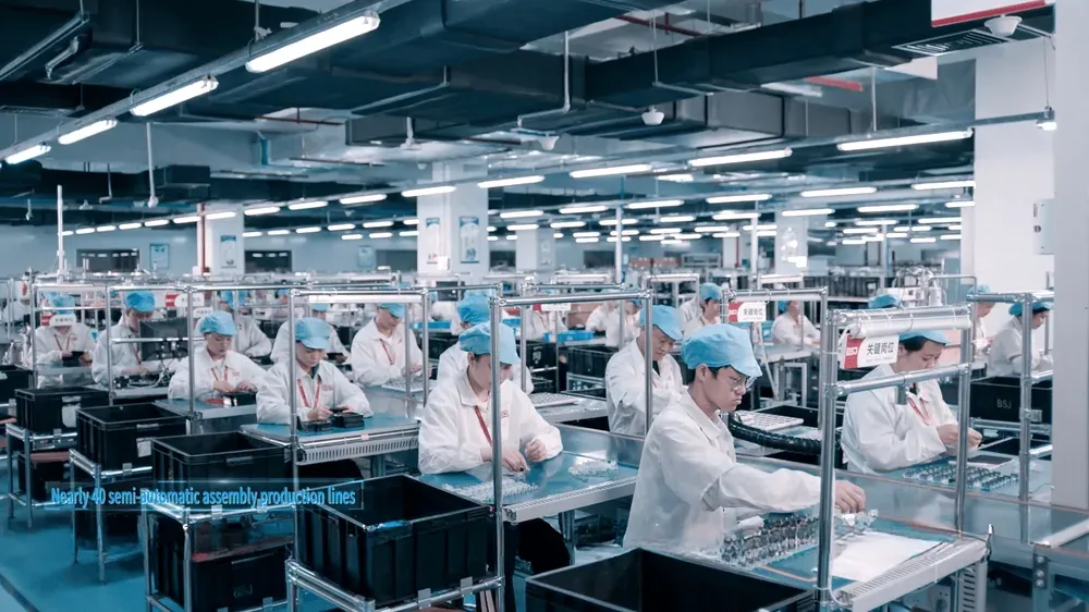 BSJ assembly hall: two rows of benches with operators fitting boards into housings.